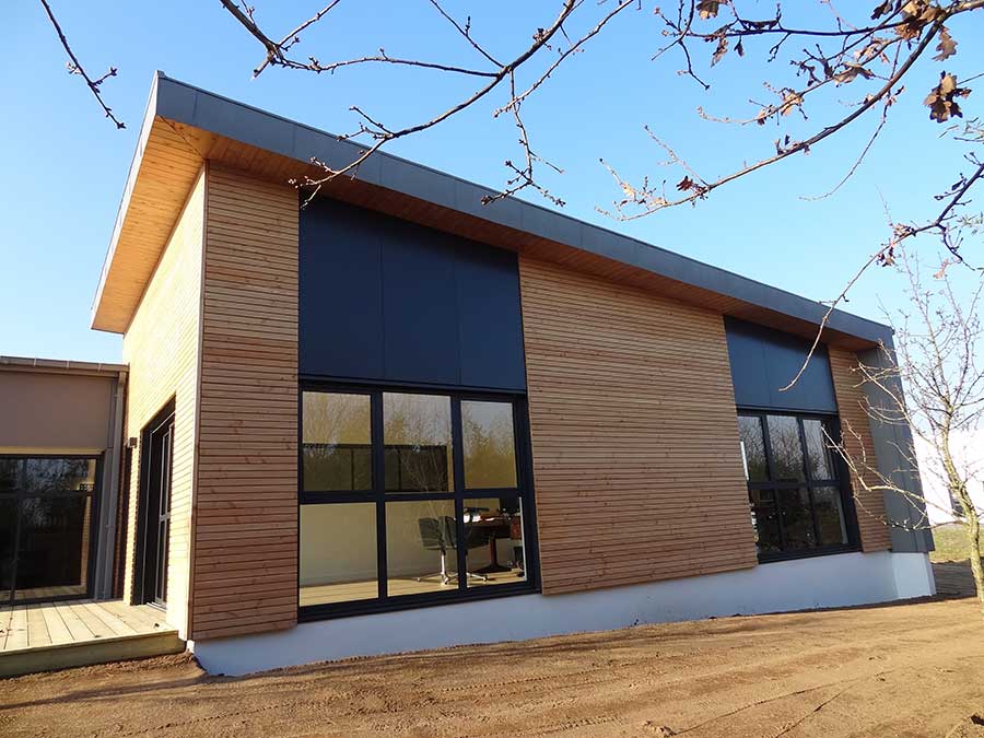 Extension de bureaux en plain-pied avec toiture mono pente zinc et bardage mixte (bois et composite), dans le Morbihan 